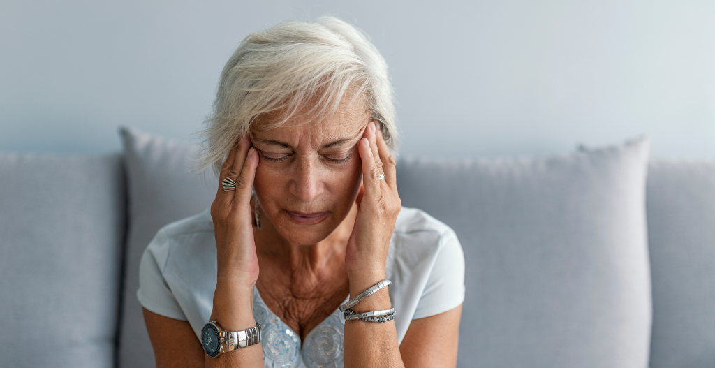 Woman with migraine holding head